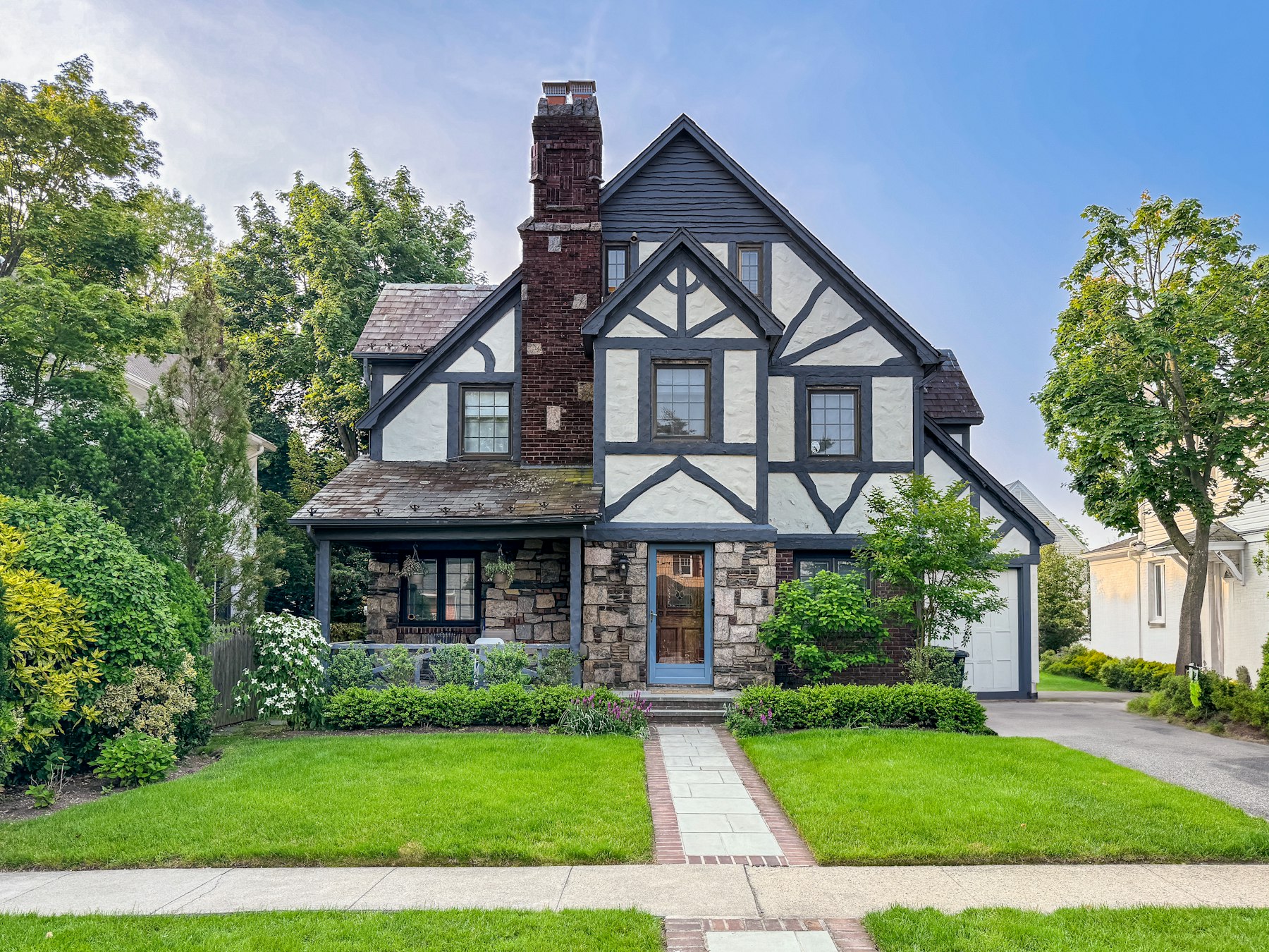 Tudor-style house with steep gables, half-timbering and mature landscaping.